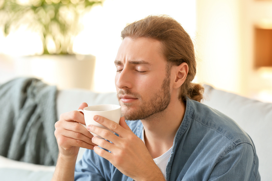 Man drinking a cup of coffee.