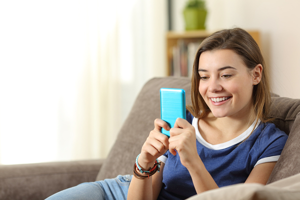 Teen looking at a smartphone with a blue case