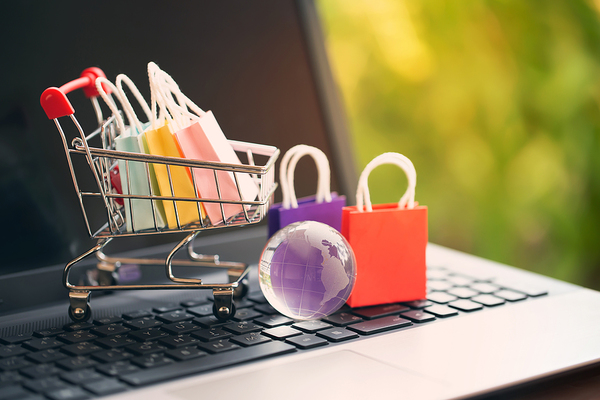 Miniature shopping cart with shopping bags.