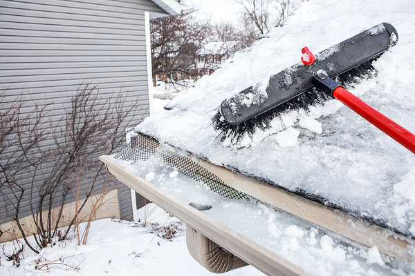 Removing snow from a roof.