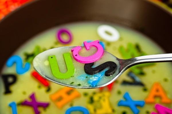 Soup with plastic multi colored letters.