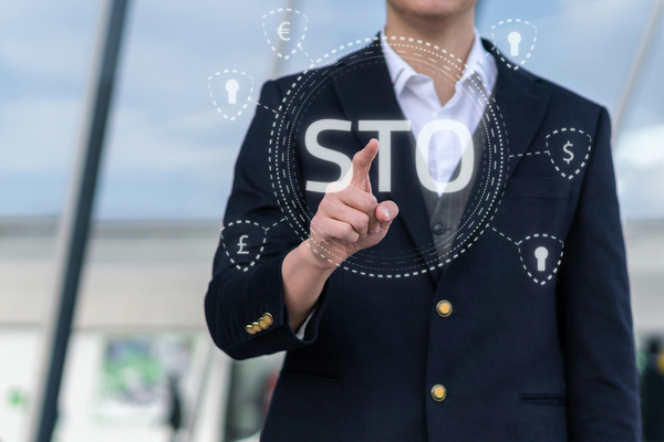 Man in a blue sport jacket pointing to the letter STO.