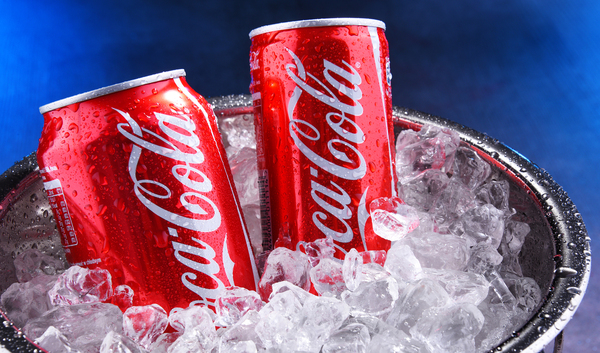 Coca-Cola cans in an ice bucket.