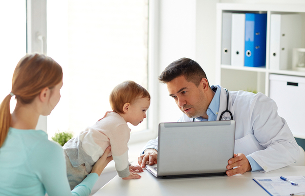 Doctor showing patient information on laptop.