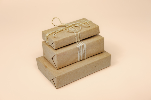 Brown paper packages tied up with strings in a stack.