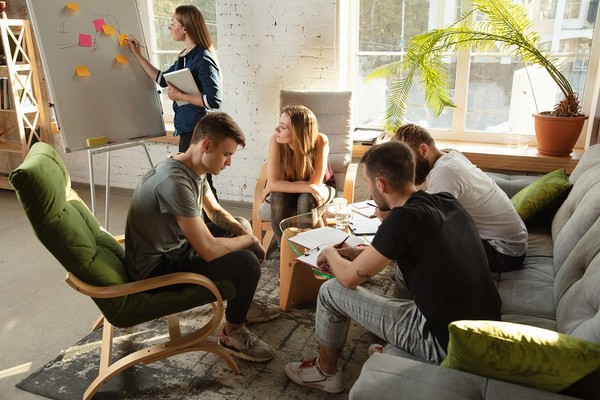 Group of colleagues sitting in a circle discussing ideas.