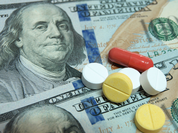 One hundred dollar pill with pills on top.