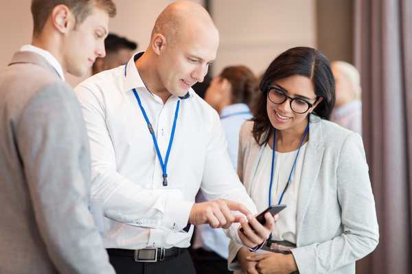 Group looking at information on a phone.