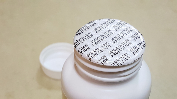Protective covering on a pill bottle.