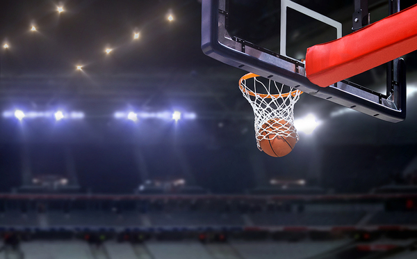 Basketball falling through a net.