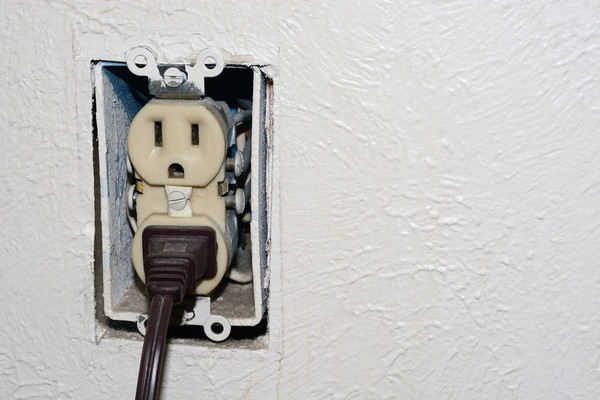 Electrical outlet with no cover.