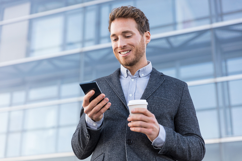 Real estate agent looking at his mobile phone