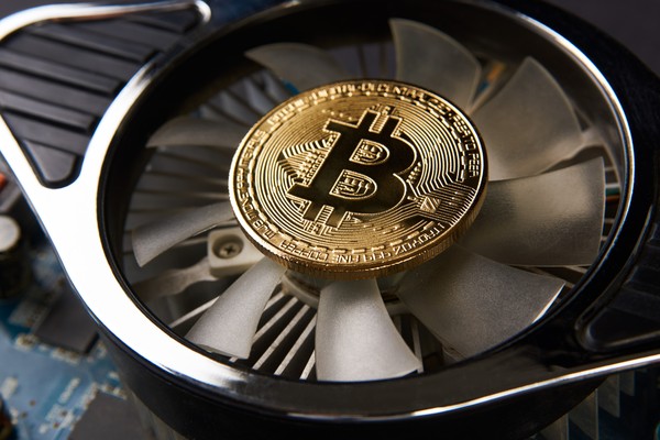 Computer fan with a gold bitcoin in the center.