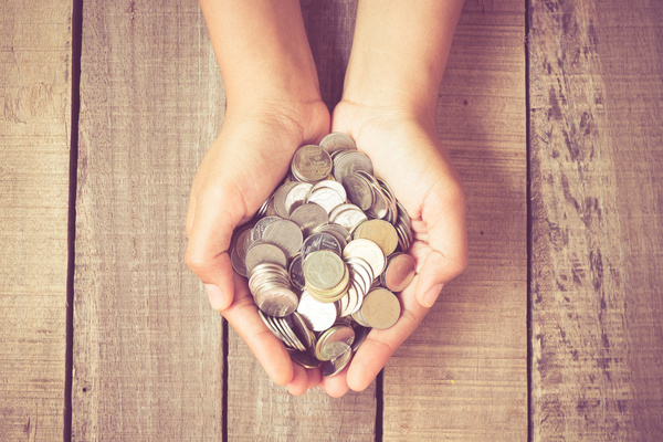 Hand filled with coins.