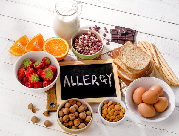 Nuts, breads and fruits on a table top.