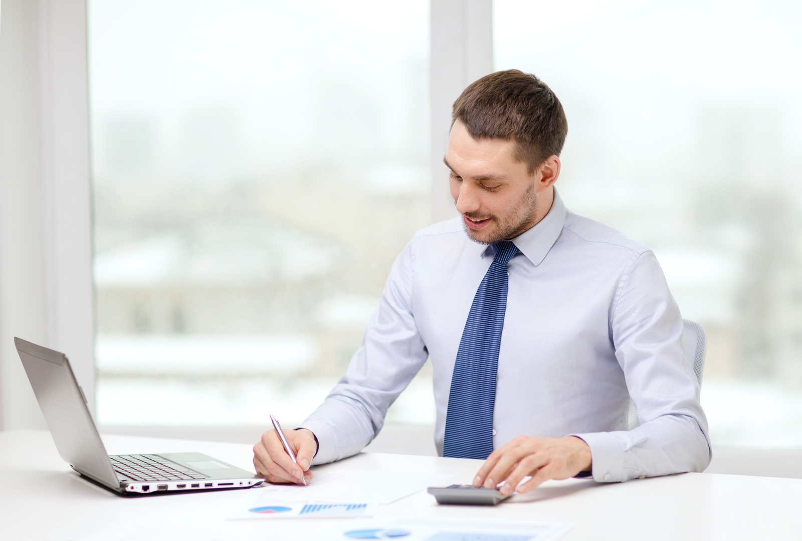 Man working while sitting at desk 