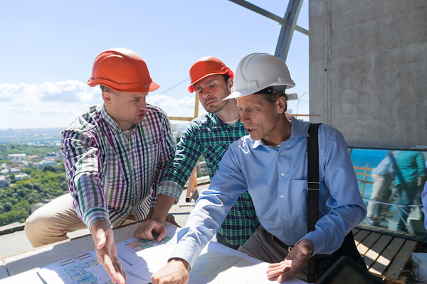 Three architects going over plans.