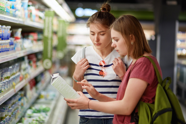 Reading a food label in a store.