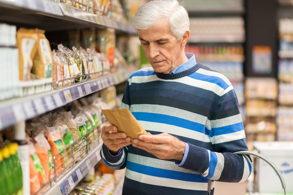 Reading a label in a grocery store.