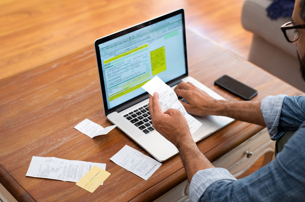 Person working at a desk with a laptop computer.
