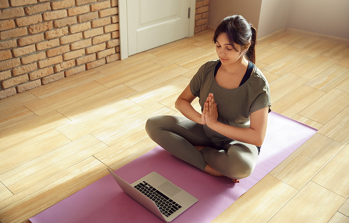 Woman sitting on the floor in a meditative position.