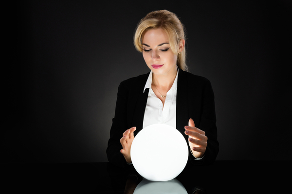 A beautiful woman staring into a lighted ball.