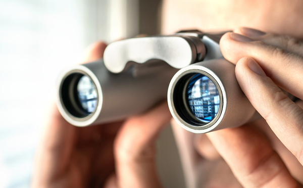 Person looking through binoculars.