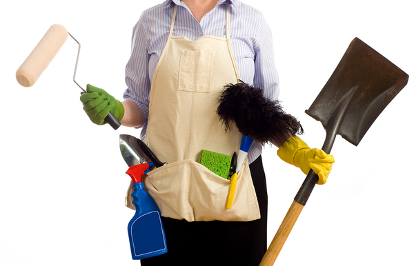 Person holding cleaning implements and tools