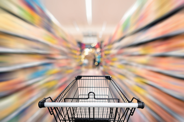 Shopping cart in a grocery store aisle.