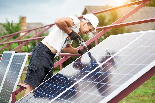 Mani installing solar panels.