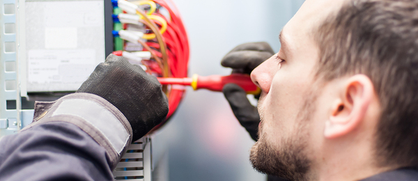 Man working on an electrical box.