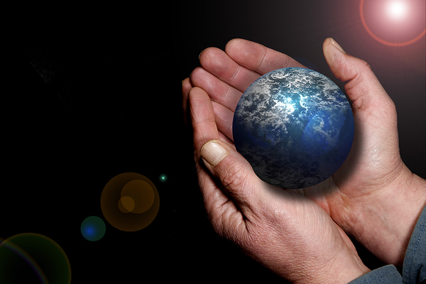 Hand holding a globe.