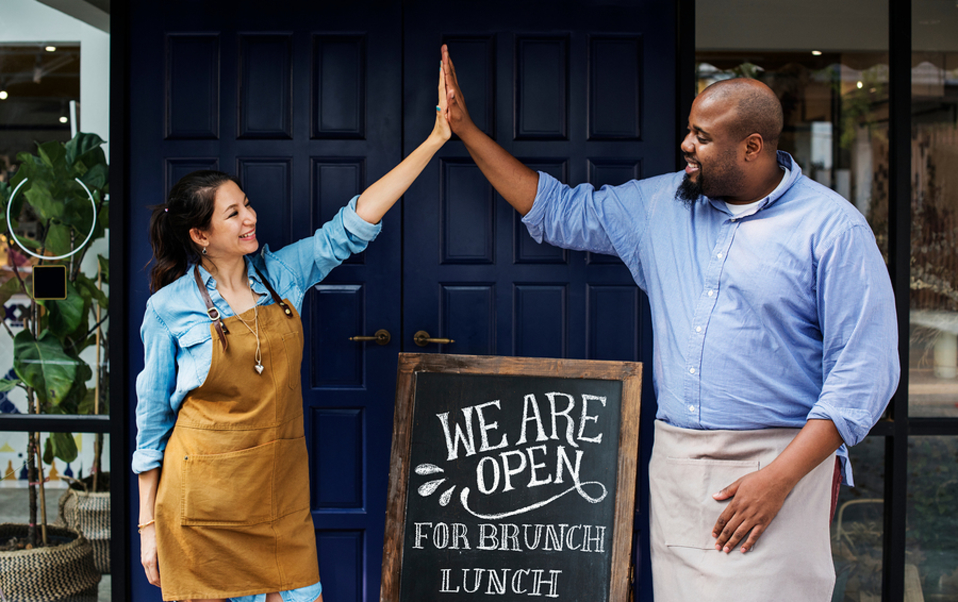 Business owners giving high five.