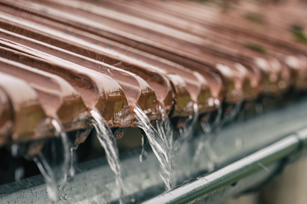 Water running off a roof into gutters.