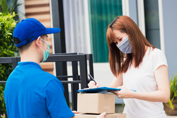 Woman signing for a package.