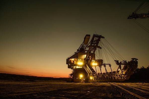 Oil rig lite up at dawn.